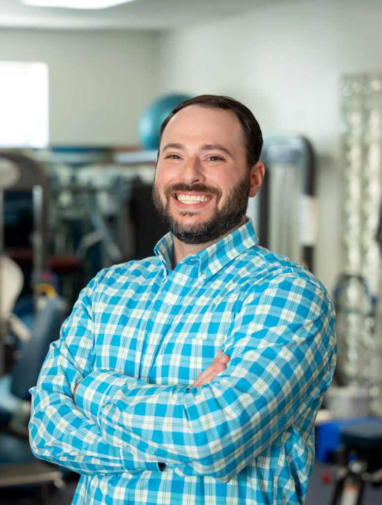 Long Island Bellmore Chiropractor Dr. Russell Brenner posing with his arms folded